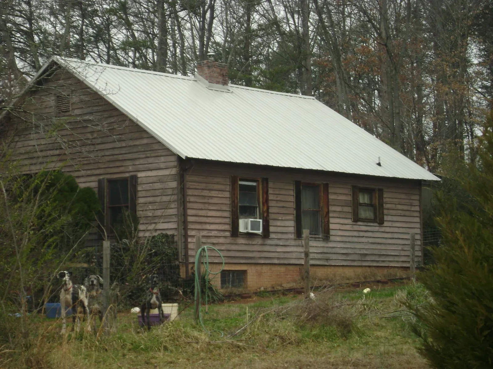 White metal roof on an old wood sided farmhouse, from a Metal Roof Installation job in East Syracuse